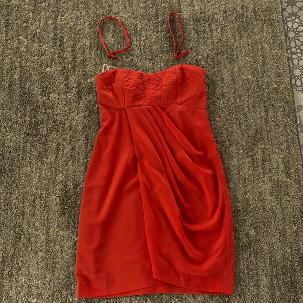Orange strapless cocktail dress.